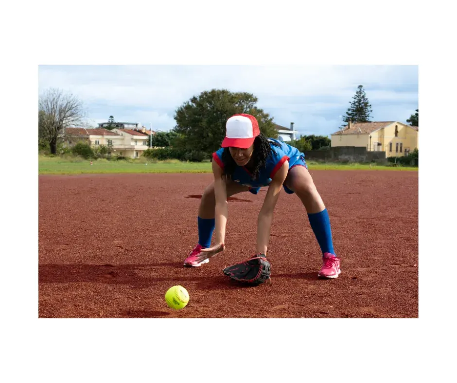 Softball player fielding a ground ball — lower-body stability, performance, and injury prevention