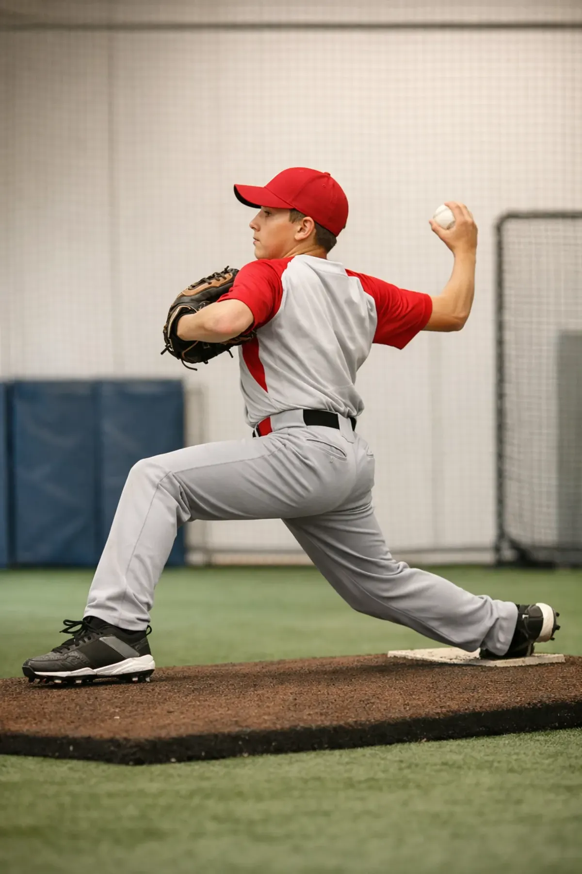 Youth baseball pitcher demonstrating proper pitching mechanics and movement quality